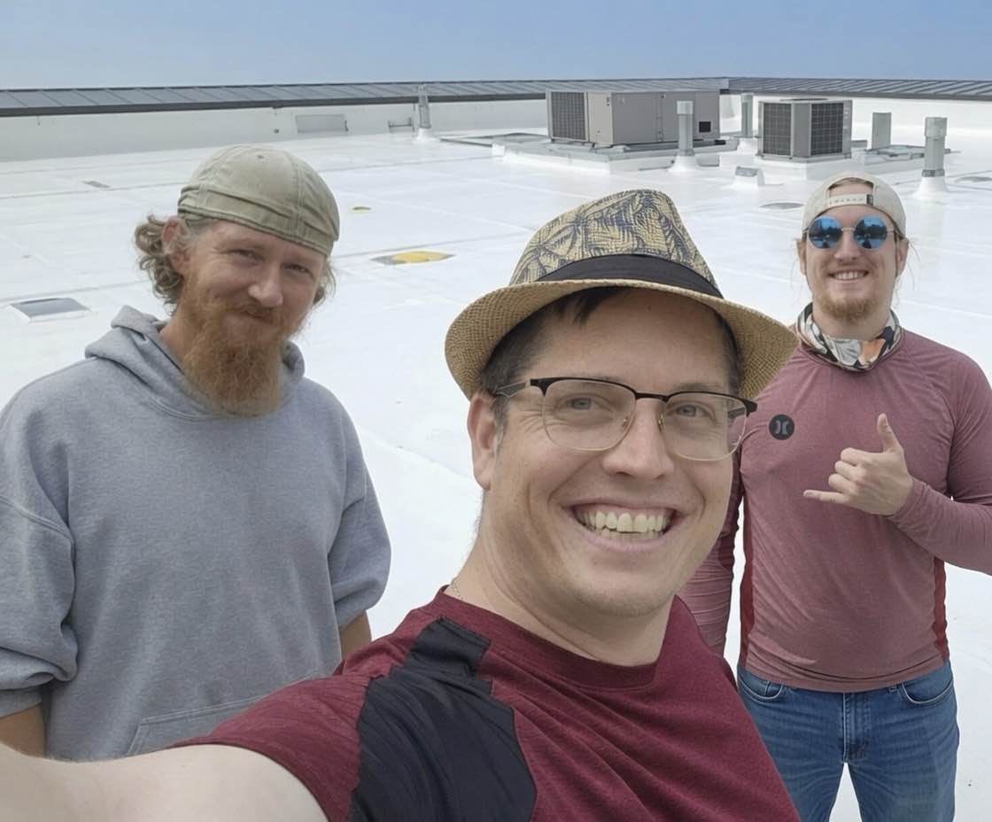 Keith, Brian, and Jason Smith, the family owners of Smith Roof Coatings, on a finished roof