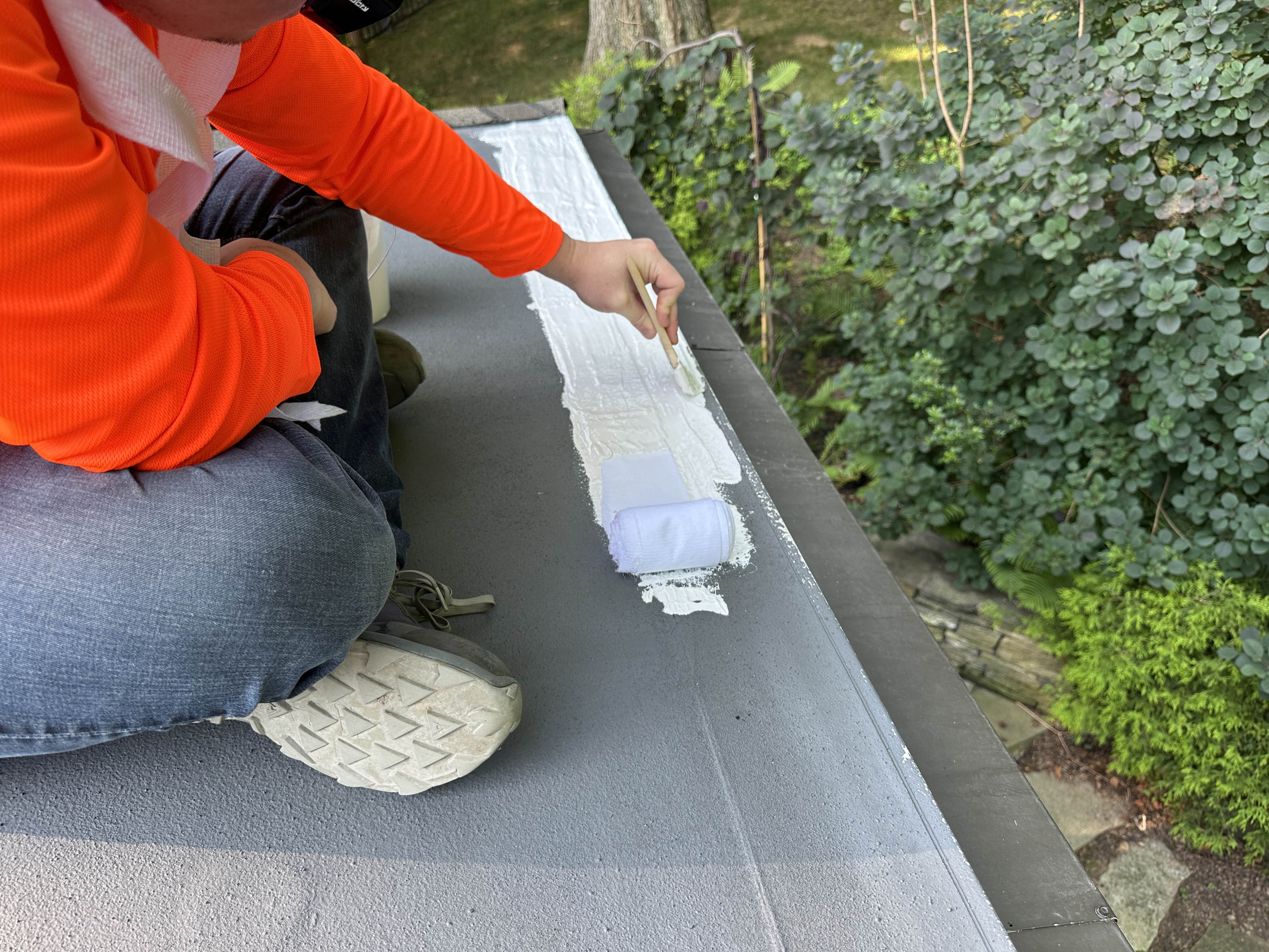 Reinforcing a roof seam with poly mesh fabric embedded in Liqui-Flash